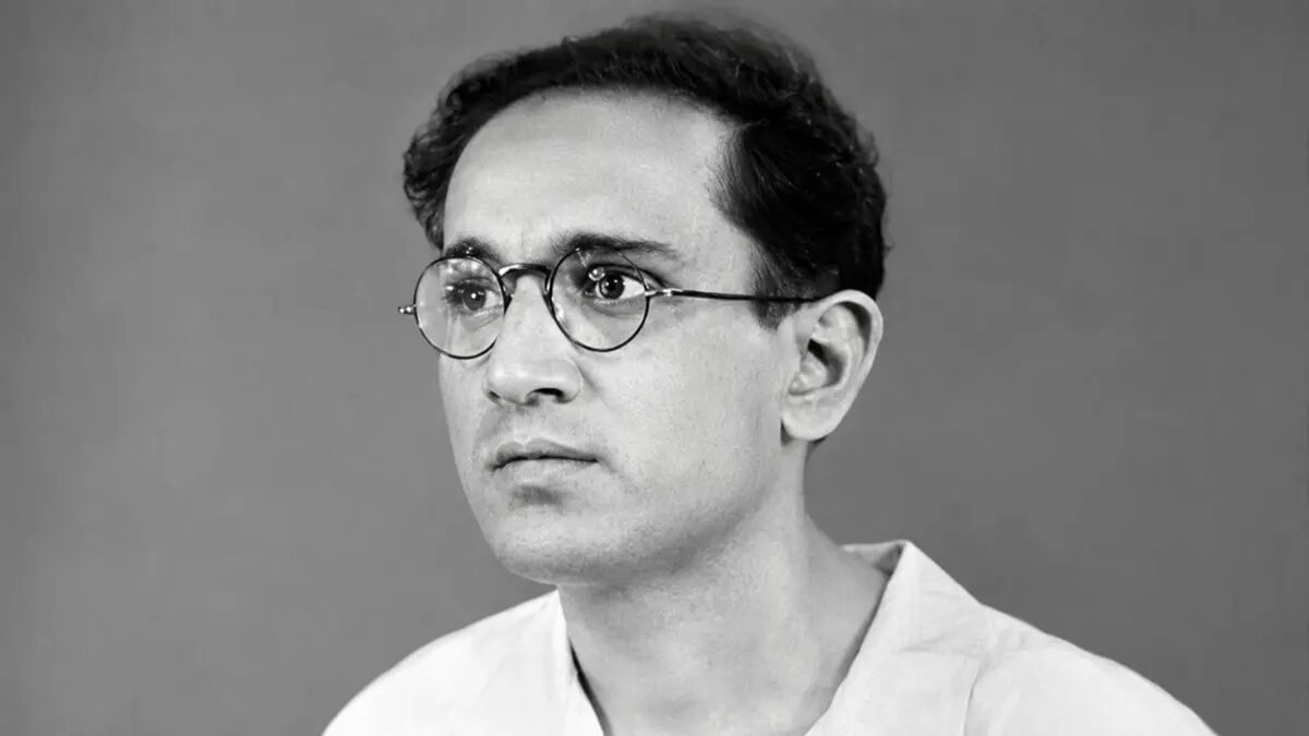 Studio portrait of Batukeshwar Dutt as a young man in round spectacles.